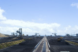 Mining Photo Stock Library - wide shot at a coal terminal looking along a ship loader to coal stockpiles and reclaimers in the background. ( Weight: 1  New Image: NO)