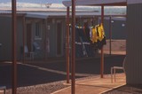 Mining Photo Stock Library - workers PPE shirts hanging on washing line in front of mine camp accomodation. ( Weight: 1  New Image: NO)