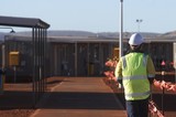 Mining Photo Stock Library - mine worker in full PPE walking through the mining camp and accomodation ( Weight: 1  New Image: NO)