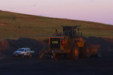 Mining Photo Stock Library - mine site worker walking around parked loader at the end of a shift.  light vehicle parked adjacent. shot in late afternoon dusk light. ( Weight: 1  New Image: NO)