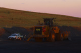 Mining Photo Stock Library - mine site worker walking around parked loader at the end of a shift.  light vehicle parked adjacent. shot in late afternoon dusk light. ( Weight: 1  New Image: NO)