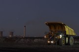 Mining Photo Stock Library - dusk photo of haul truck unloading overburden in open cut coal mine.  power station in background. ( Weight: 1  New Image: NO)