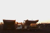 Mining Photo Stock Library - mine site service truck with haul trucks at the go line. shot at dawn. ( Weight: 1  New Image: NO)