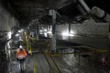 Mining Photo Stock Library - underground coal mine worker engineer walking through tunnel with coal conveyors moving above.  qide photo. ( Weight: 1  New Image: NO)