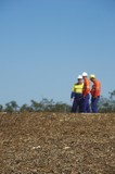 Mining Photo Stock Library - three mine site workers in full PPE in discussion.    vertical shot. ( Weight: 1  New Image: NO)