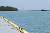 Mining Photo Stock Library - looking over edge of a marine jetty with boats and mangroves on the horizon line. ( Weight: 1  New Image: NO)