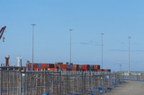 Mining Photo Stock Library - photo of temporary fencing around ship at port.  shipping containers stacked on wharf.  bluer sky behind. ( Weight: 1  New Image: NO)