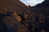Mining Photo Stock Library - close up photo of coal with mine workers male and female in full PPE in background out of focus.  shot at dusk with great afternoon light.  vertical photo. ( Weight: 1  New Image: NO)