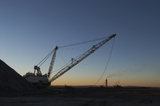 Mining Photo Stock Library - dragline at open cut coal mine in afternoon light with coal fired power station stacks in background. ( Weight: 2  New Image: NO)